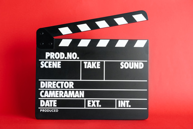 Photo of Clapper board on red background. Cinema production