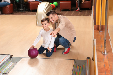 Father and son spending time together in bowling club