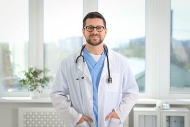Photo of Portrait of smiling doctor with stethoscope in hospital