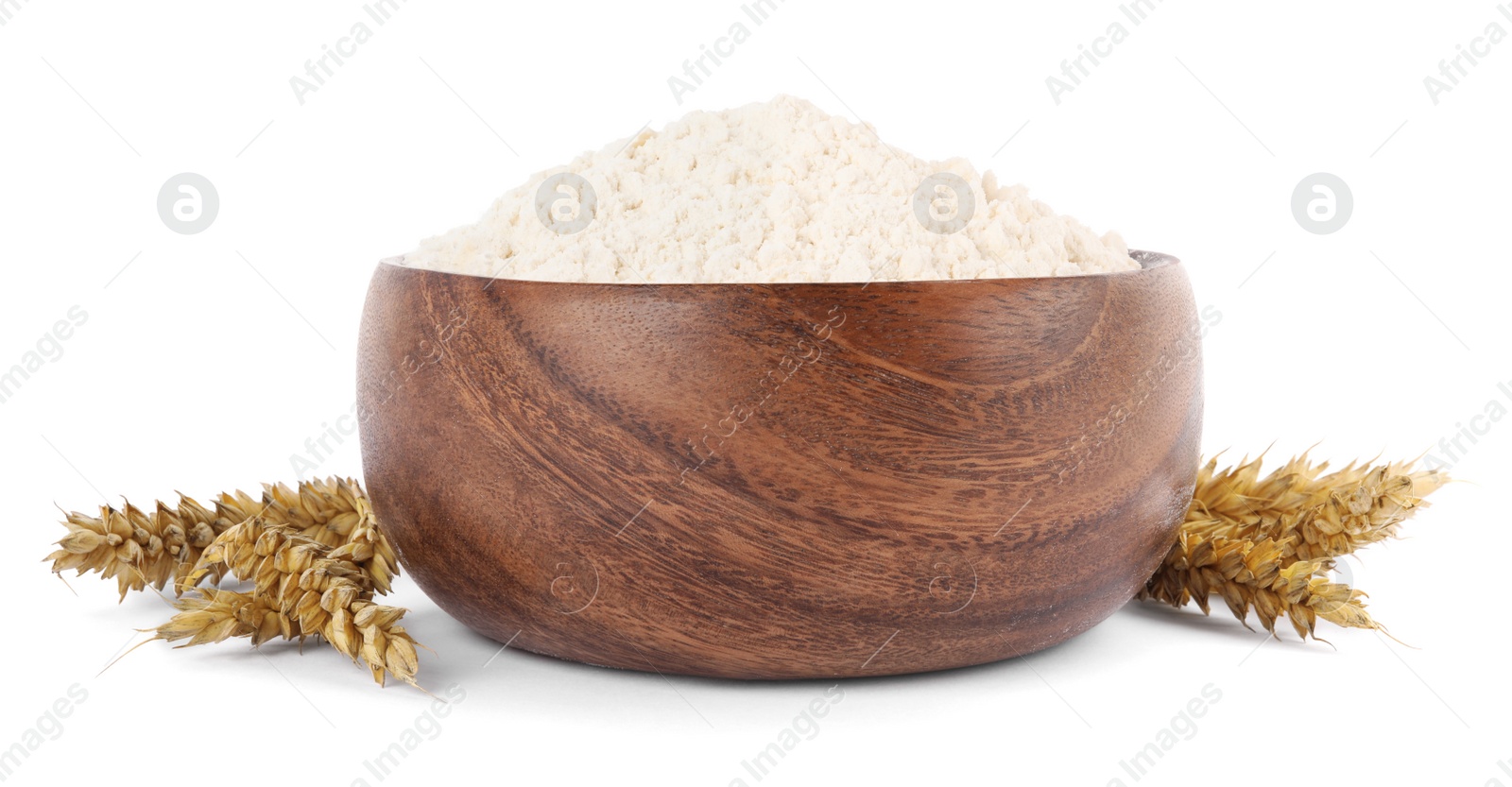 Photo of Wooden bowl of organic wheat flour isolated on white