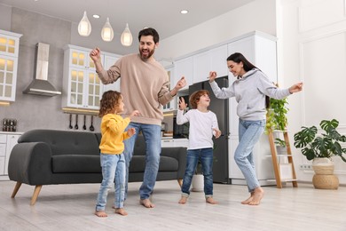 Photo of Happy family dancing and having fun at home, low angle view