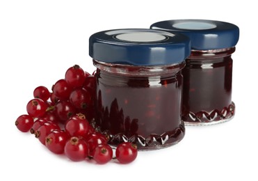 Photo of Jars with sweet jam and fresh berries on white background