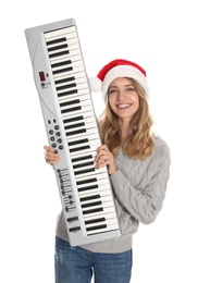 Photo of Young woman in Santa hat with synthesizer on white background. Christmas music