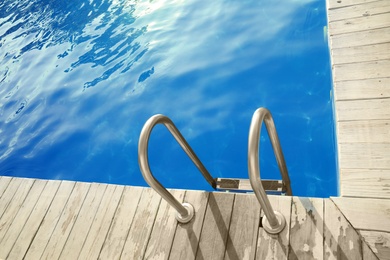 Photo of Modern swimming pool with step ladder outdoor