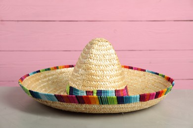 Photo of Mexican sombrero hat on grey table, closeup