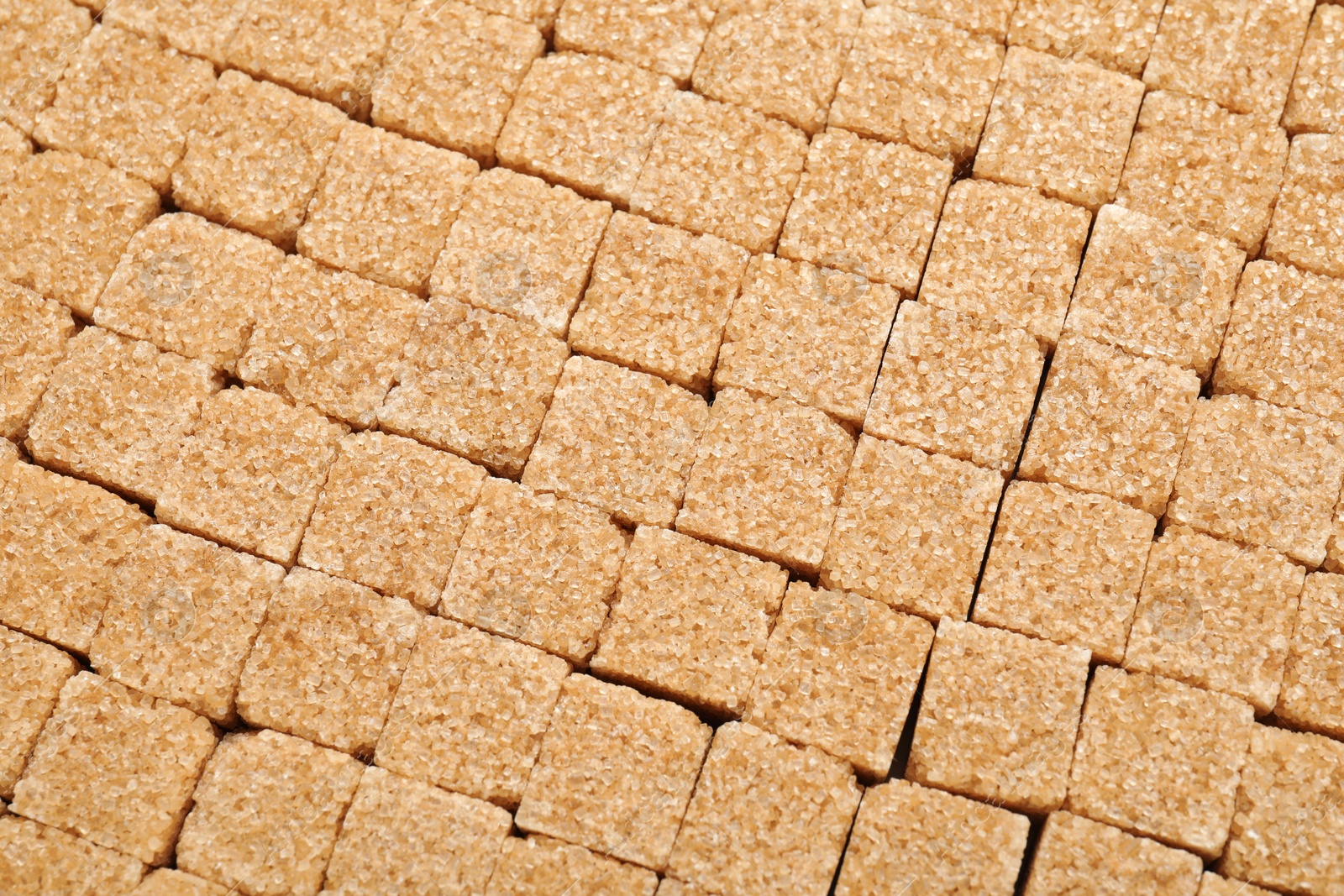 Photo of Brown sugar cubes as background, top view