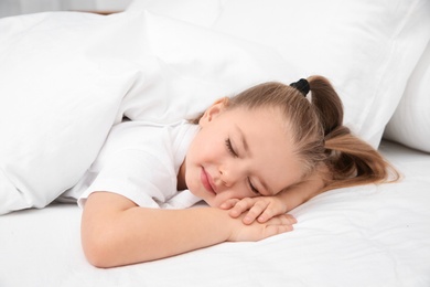 Photo of Beautiful little girl sleeping in bed. Bedtime schedule