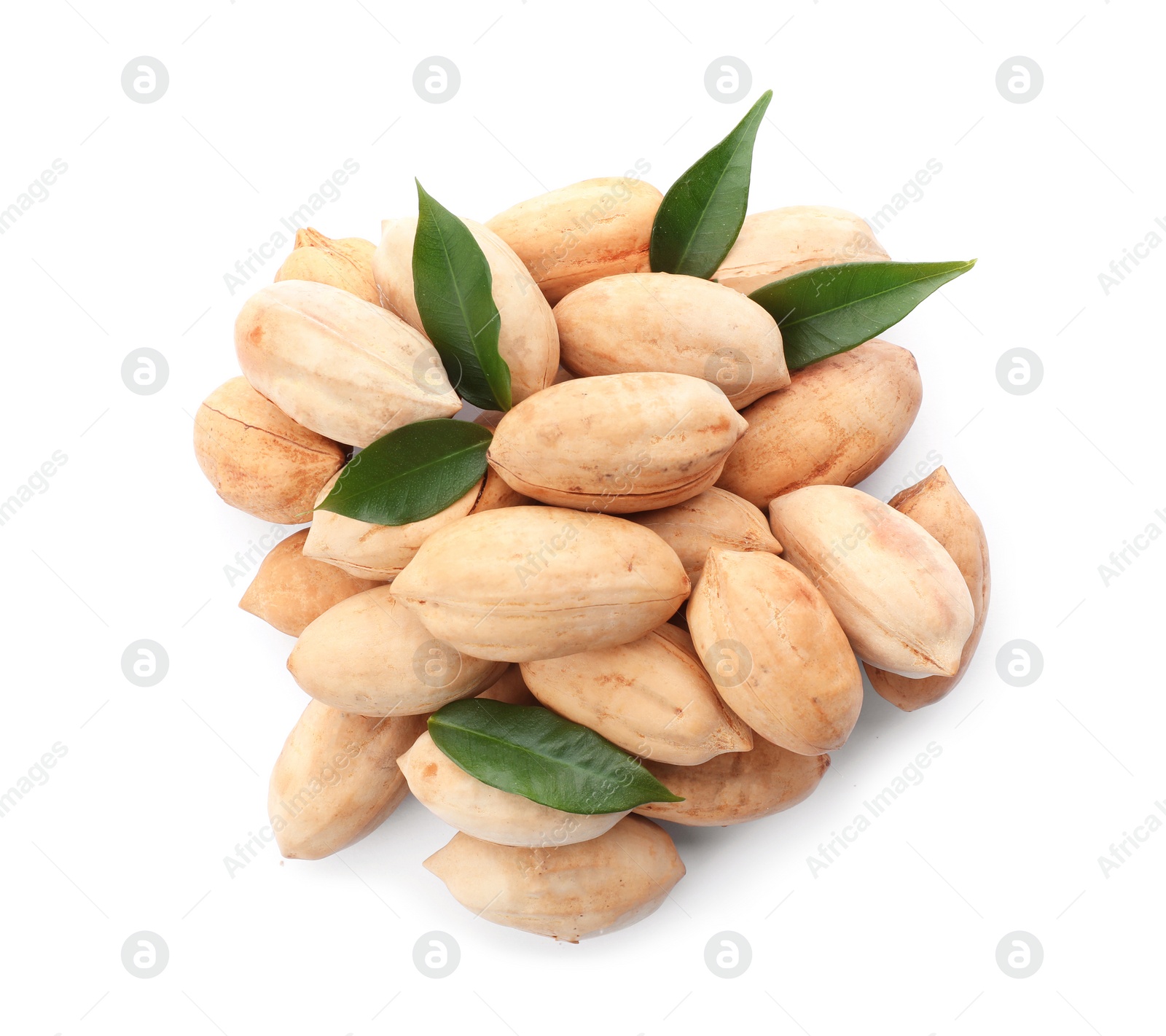 Photo of Heap of pecan nuts in shell and leaves on white background, top view