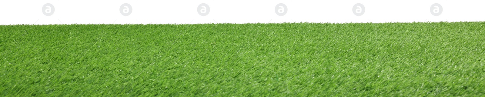 Photo of Green artificial grass surface isolated on white