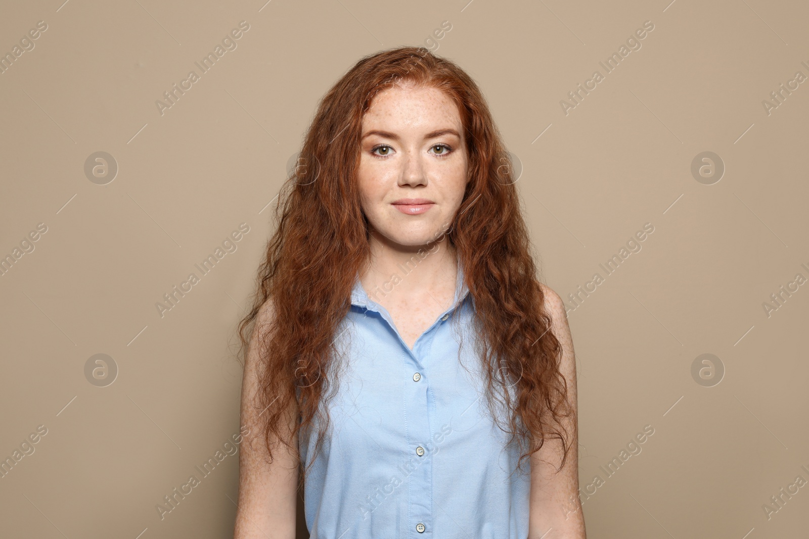 Photo of Portrait of young woman with beautiful face on beige background