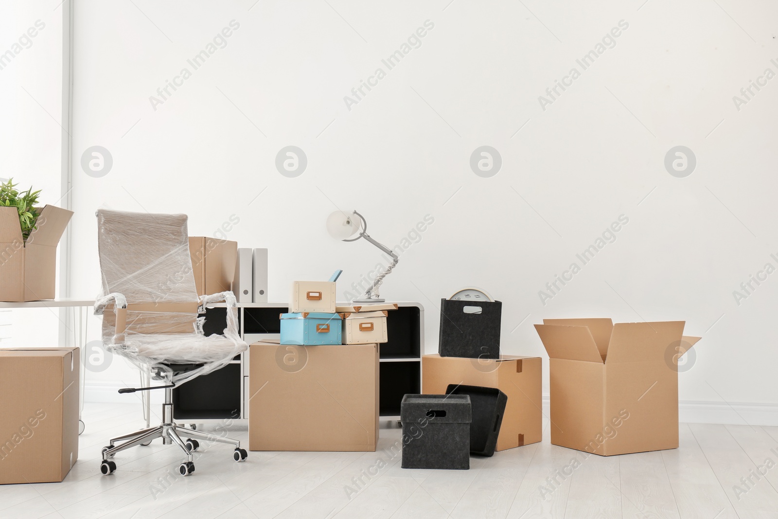 Photo of Moving boxes and furniture in new office