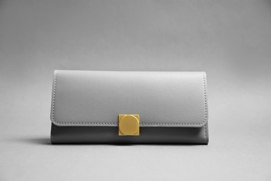 Photo of Stylish leather purse on light grey background