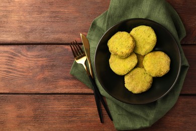 Photo of Tasty vegan cutlets served on wooden table, top view. Space for text