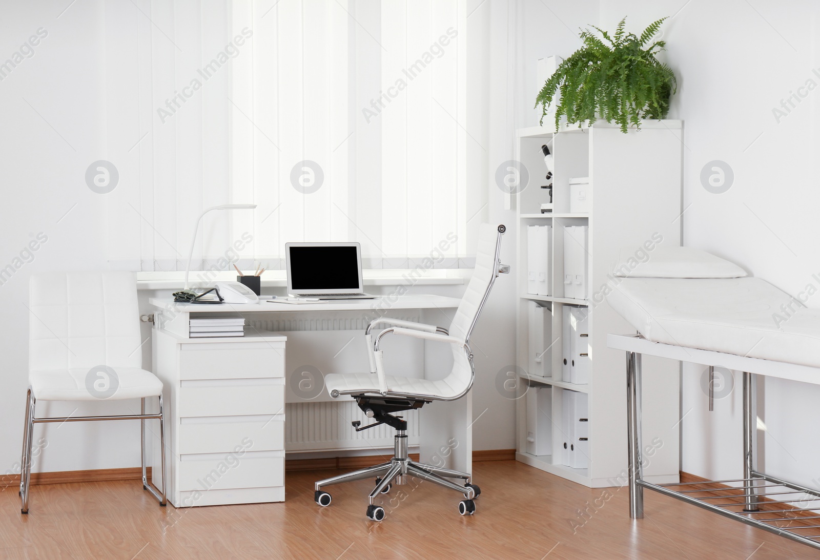 Photo of Interior of modern medical office with doctor's workplace