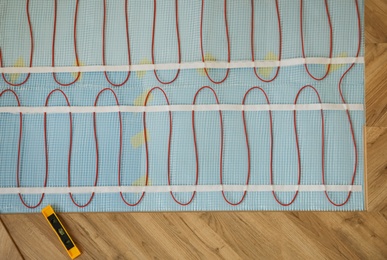 Photo of Installation of electric underfloor heating system indoors, top view