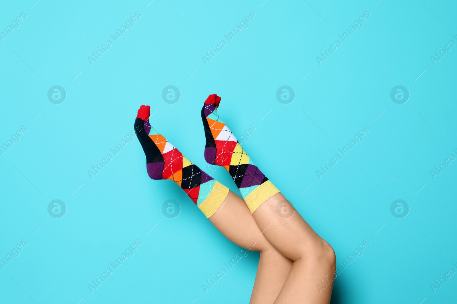 Photo of Woman wearing bright socks on color background