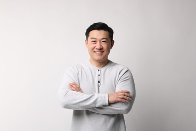 Portrait of happy man on light background