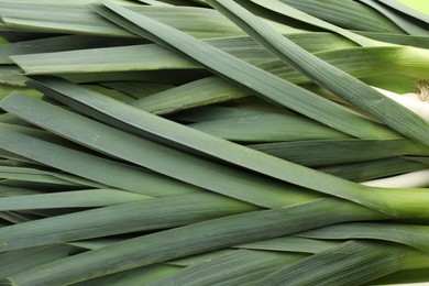 Photo of Fresh raw leeks as background, top view