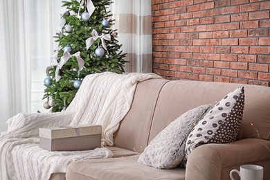 Decorated Christmas tree in stylish living room interior