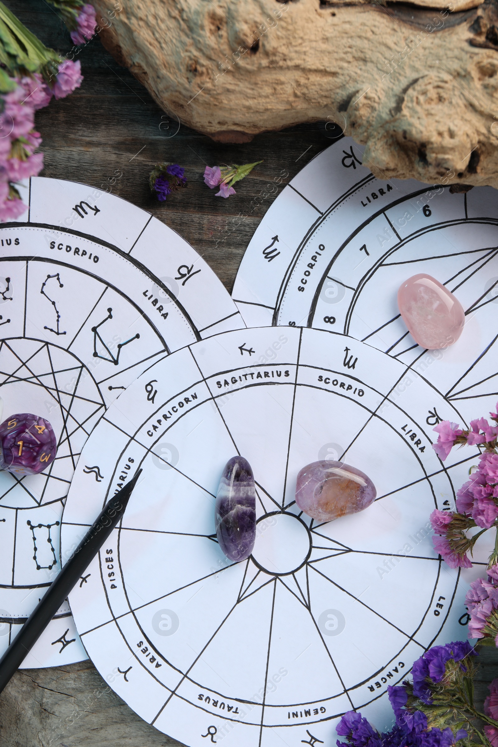 Photo of Flat lay composition with zodiac wheels and astrology dices on wooden table