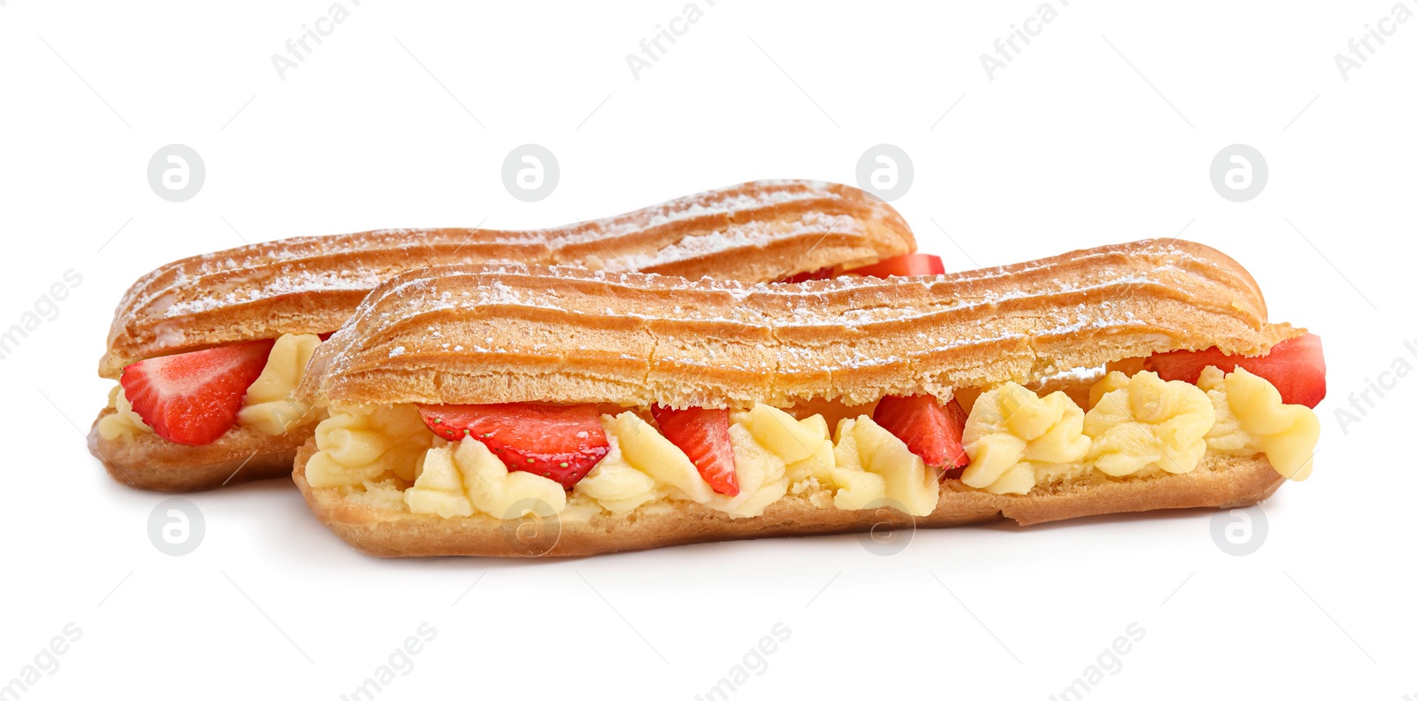 Photo of Delicious eclairs filled with cream and strawberries isolated on white