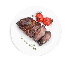 Plate with delicious beef meat, thyme and tomatoes isolated on white, top view