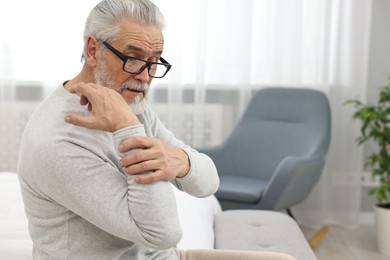 Arthritis symptoms. Man suffering from pain in hand at home