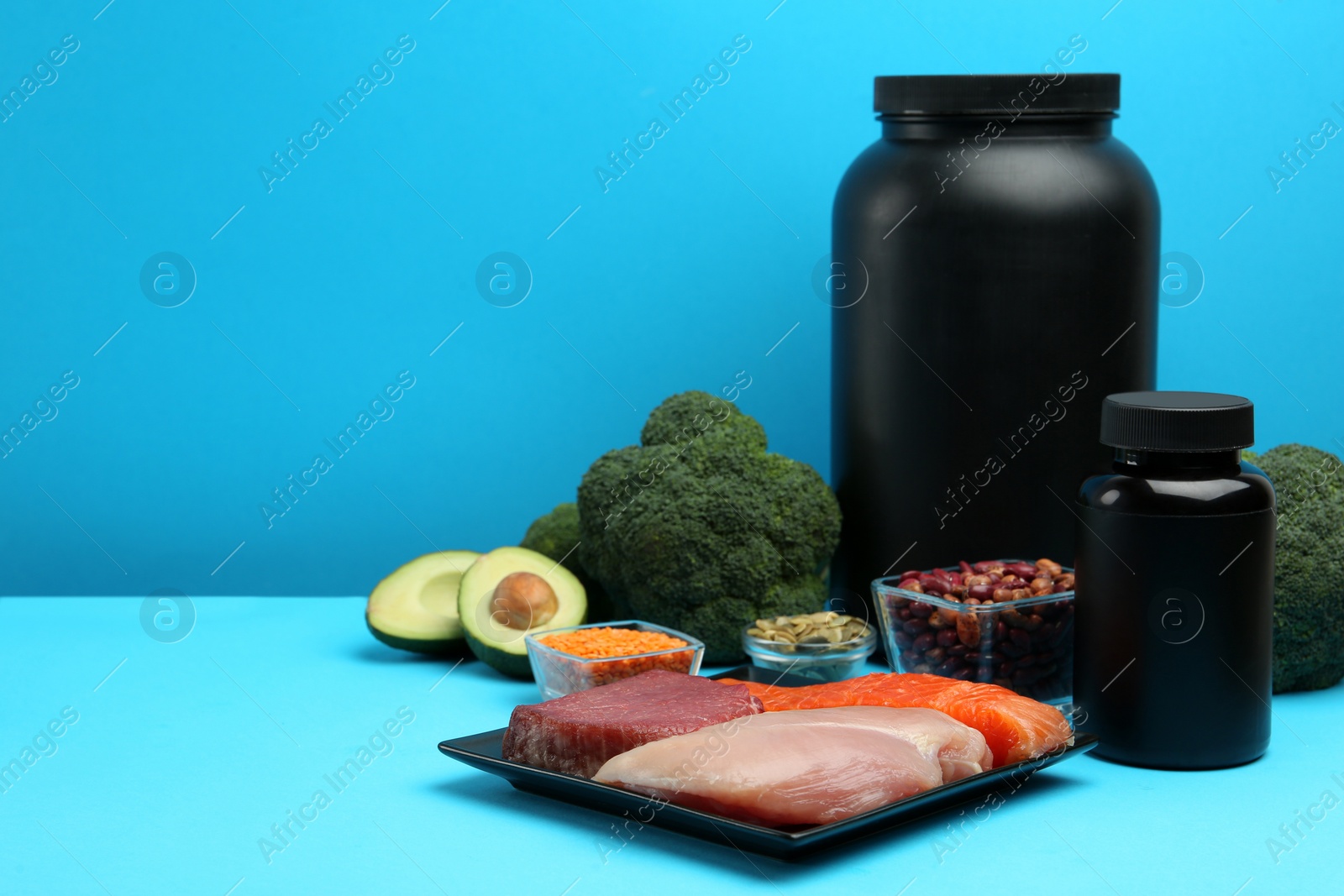 Photo of Set of products rich in amino acids and supplements on light blue background. Space for text