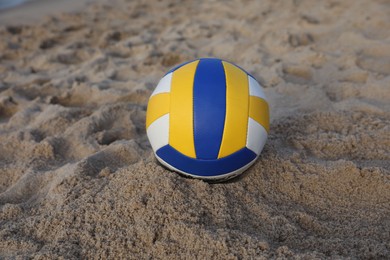 Photo of Colorful leather volleyball ball on sandy beach