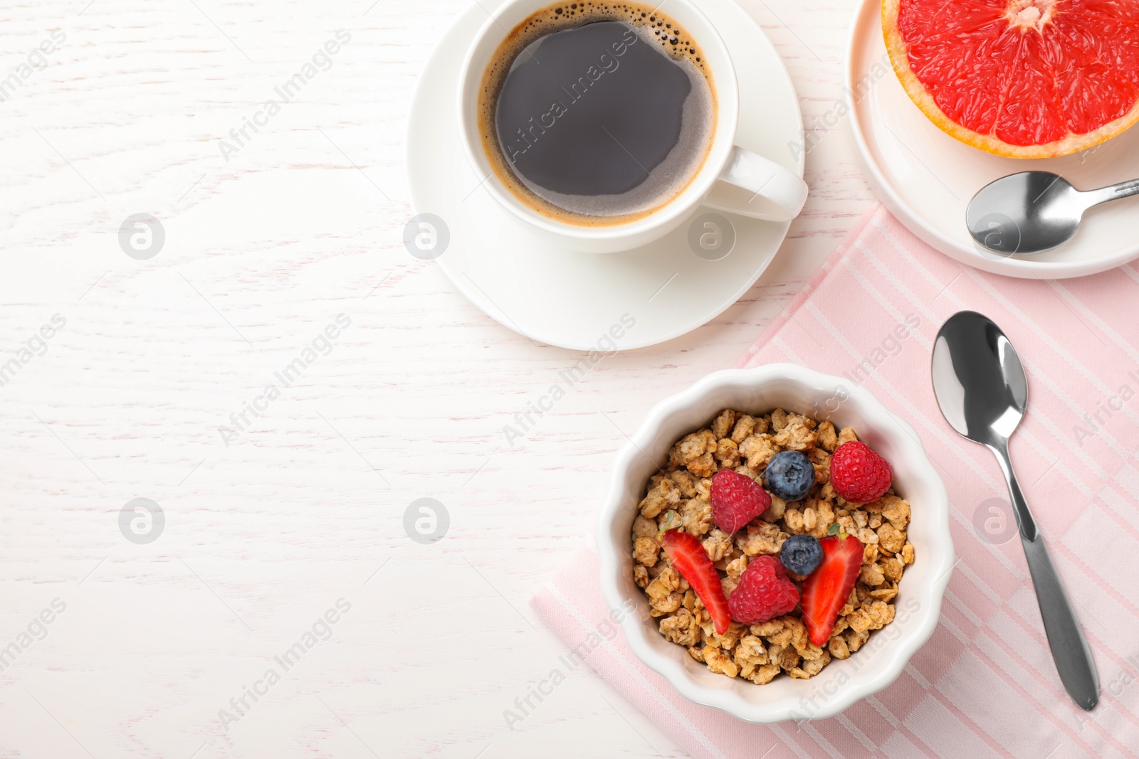 Photo of Tasty breakfast served on white wooden table, flat lay. Space for text