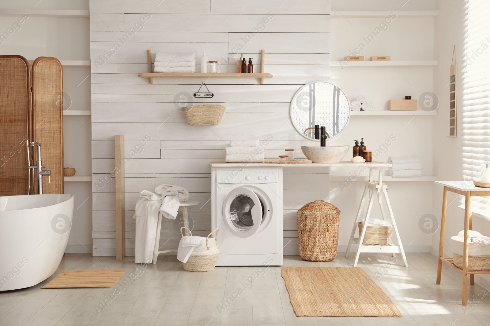 Photo of Stylish bathroom interior with modern washing machine