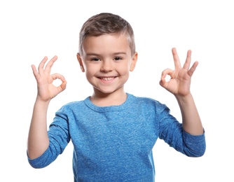 Photo of Little boy showing OK gesture in sign language on white background