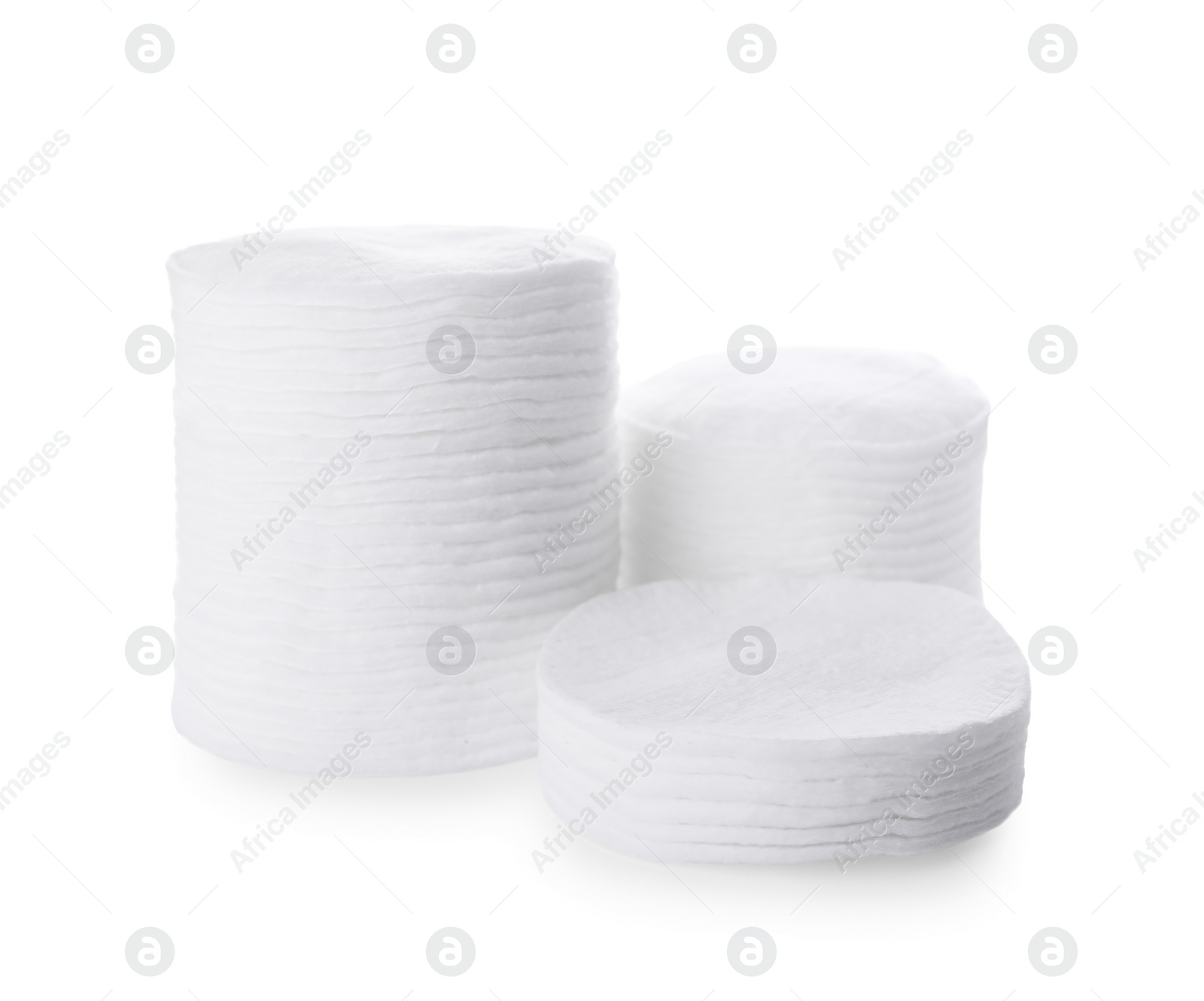 Photo of Stacks of cotton pads on white background