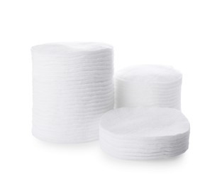 Photo of Stacks of cotton pads on white background