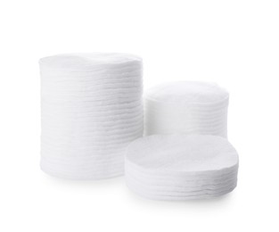 Stacks of cotton pads on white background