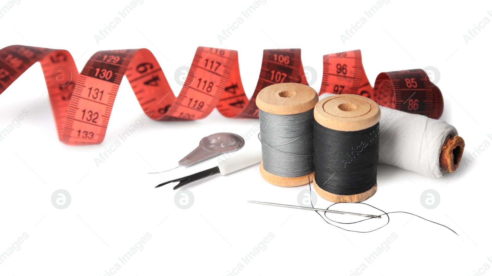 Photo of Set of sewing accessories on white background