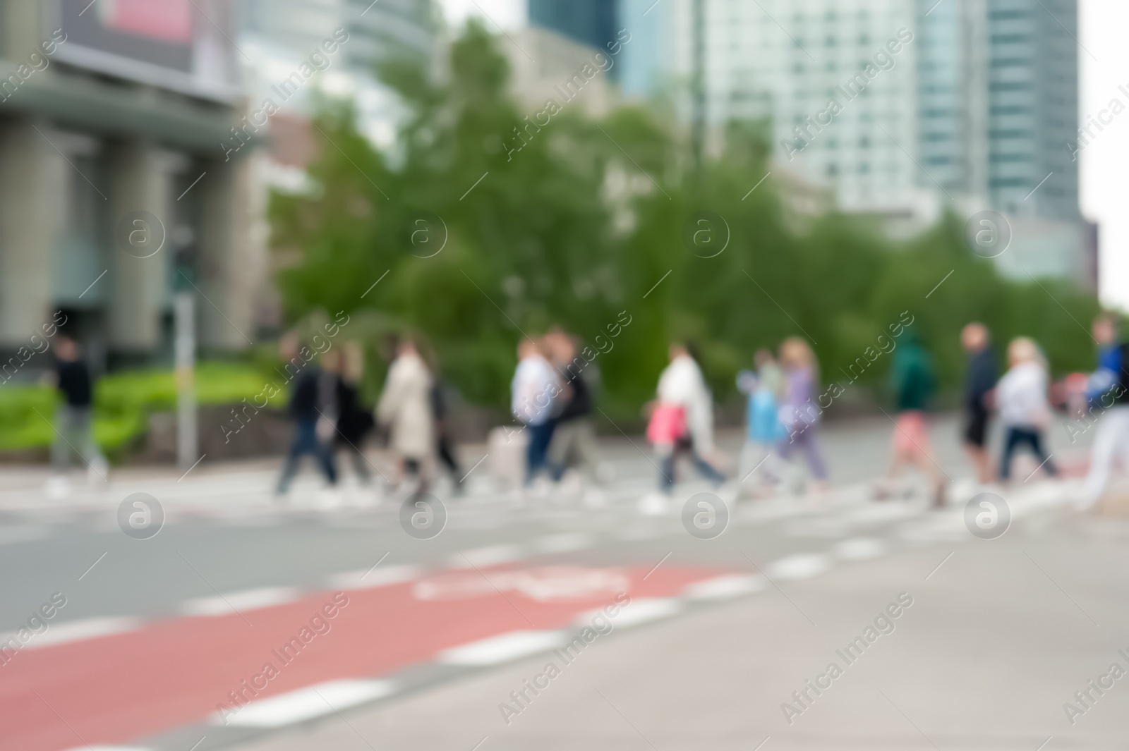 Photo of People crossing street in city, blurred view