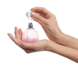 Young woman with perfume bottle on white background, closeup