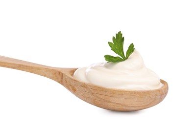 Photo of Delicious sour cream with parsley in wooden spoon on white background