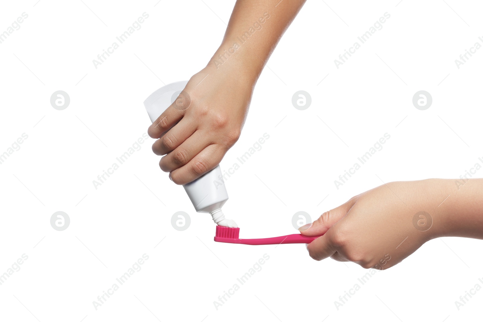 Photo of Woman applying toothpaste on brush against white background, closeup