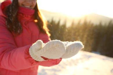 Young woman having fun outdoors on snowy winter day, closeup