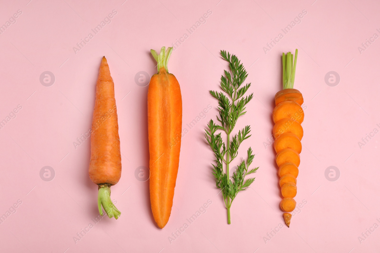 Photo of Creative flat lay composition with fresh ripe carrots on color background