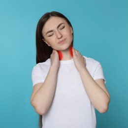 Woman suffering from rheumatism on light blue background