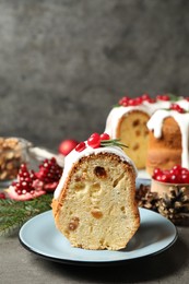 Composition with piece of traditional homemade Christmas cake on grey table, closeup