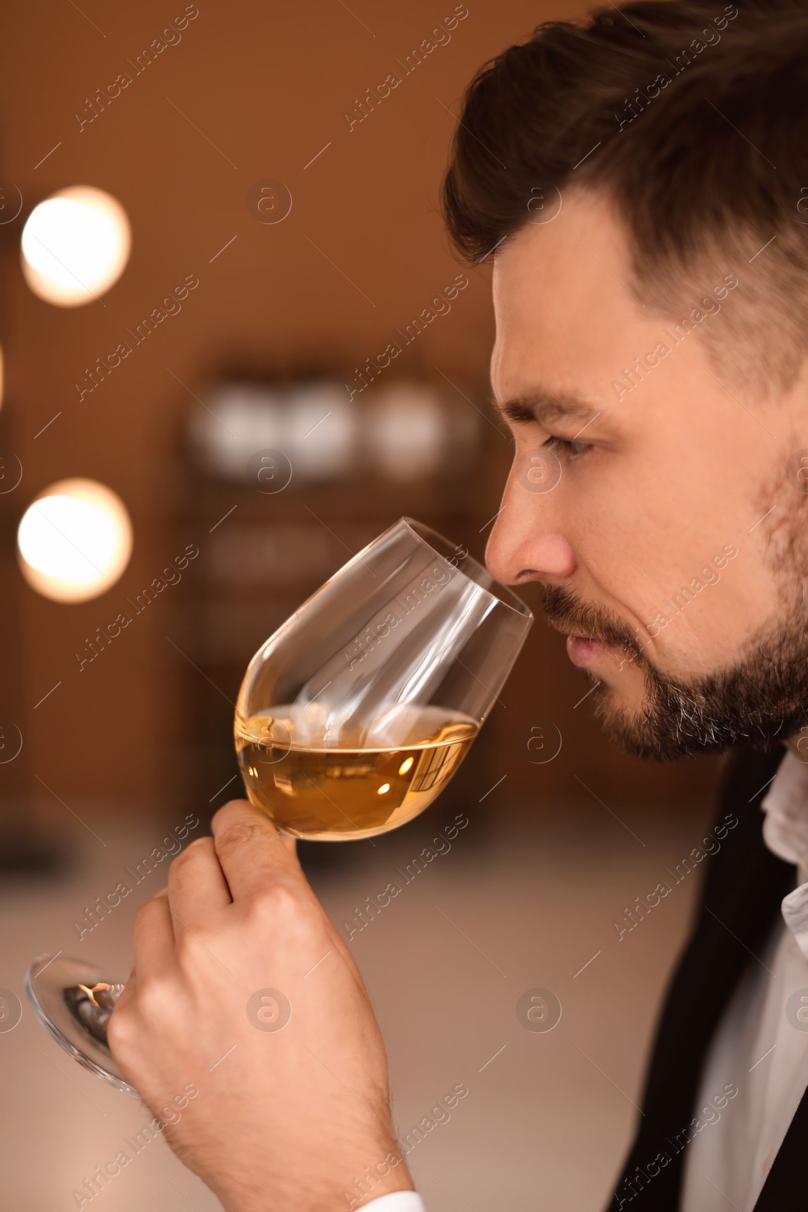 Photo of Young man with glass of wine indoors