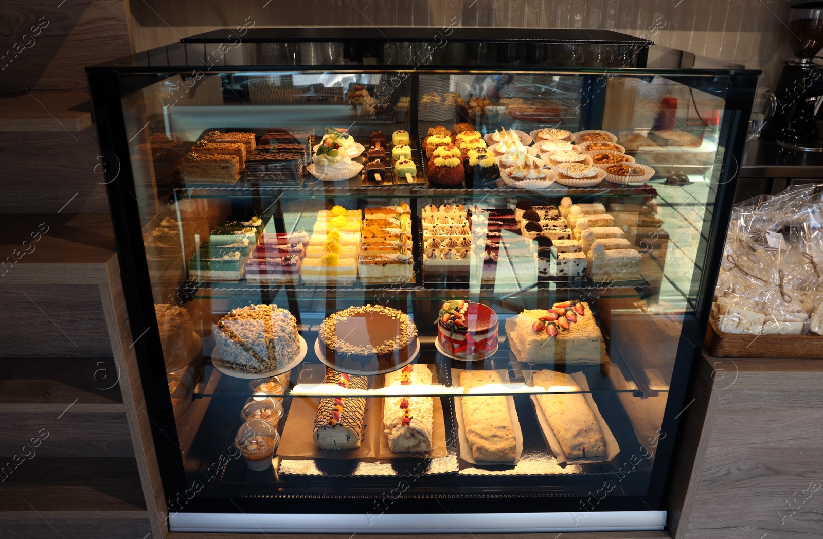 Photo of Counter with different tasty desserts in bakery shop