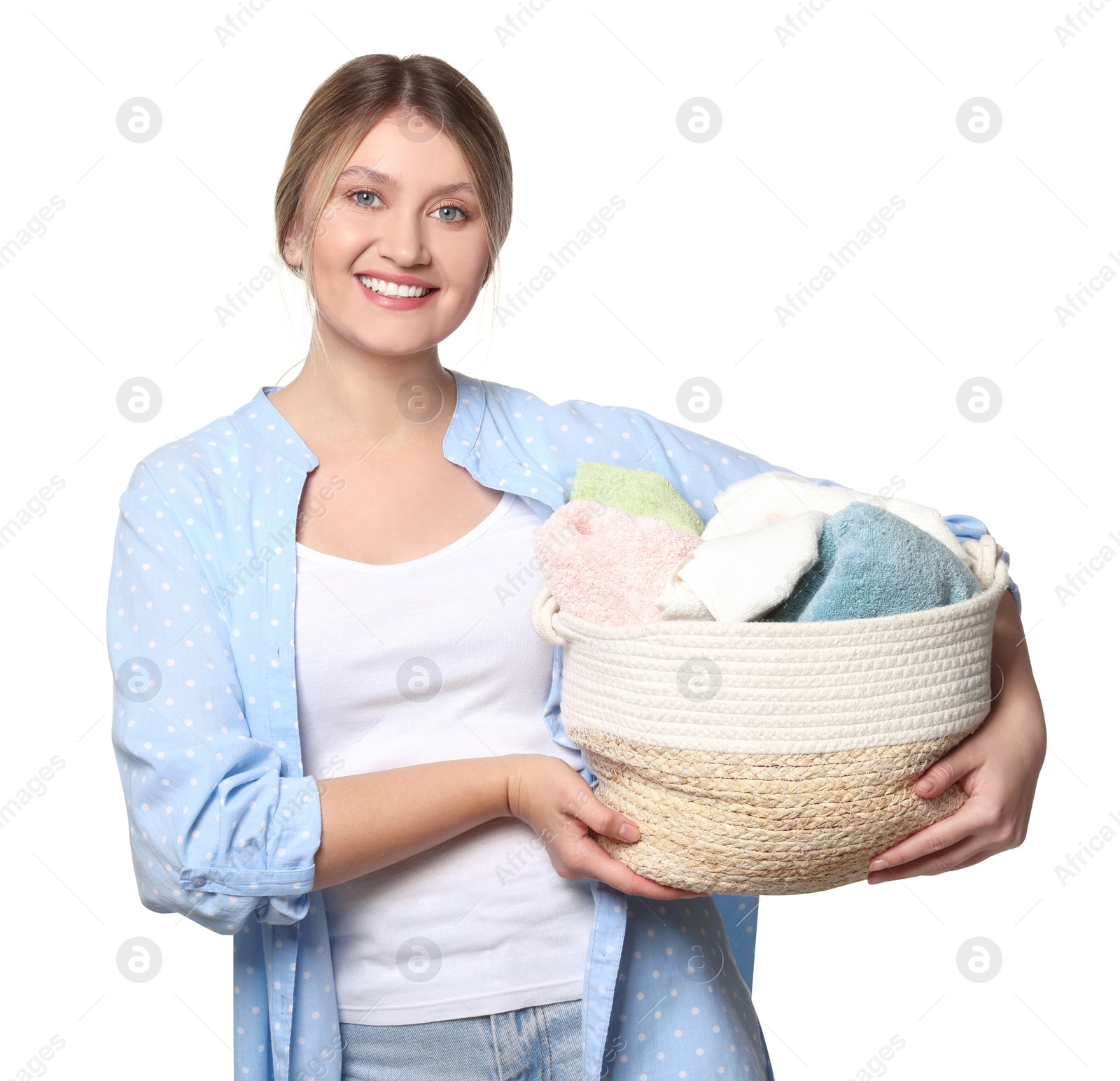 Photo of Happy woman with basket full of laundry on white background