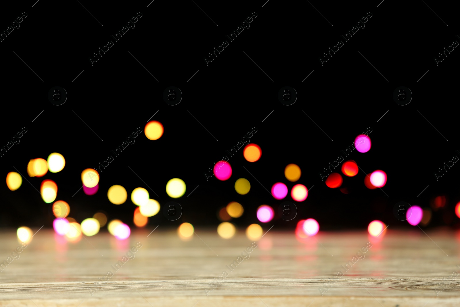 Photo of Blurred view of beautiful lights on black background. Bokeh effect