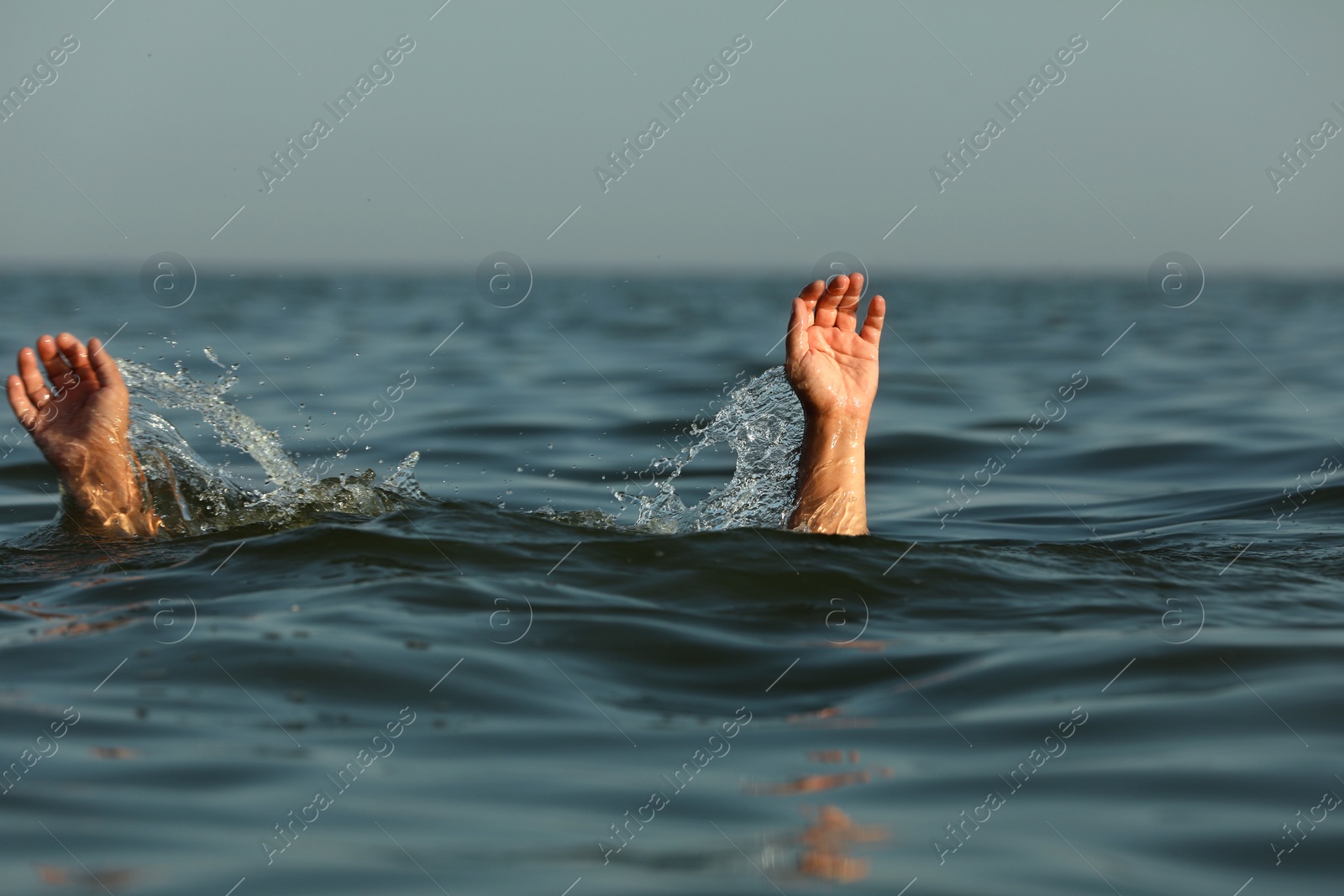 Photo of Drowning man reaching for help in sea