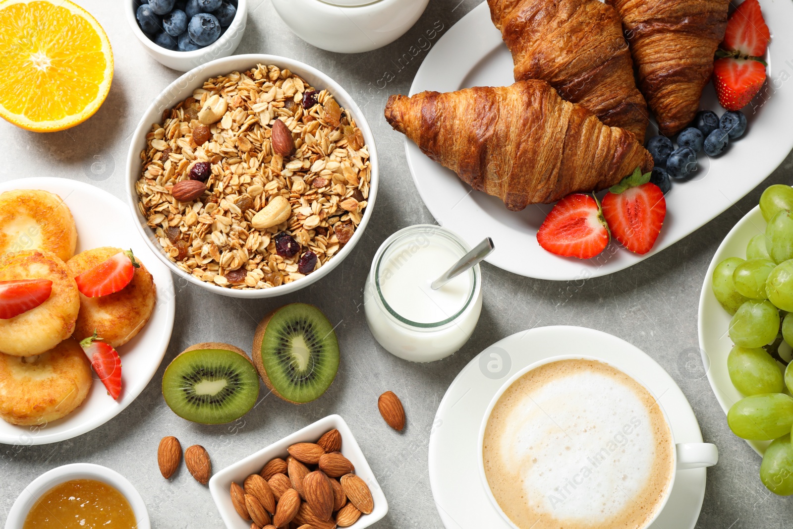 Photo of Buffet service. Tasty breakfast served on light grey table, flat lay